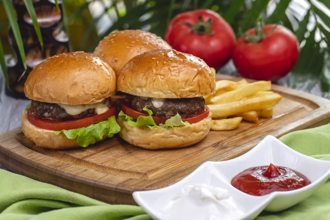 AnyConv.com__side-view-meat-burgers-with-french-fries-ketchup-mayonnaise-board